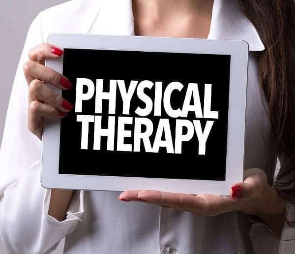 Women holding a sign saying Physical Therapy