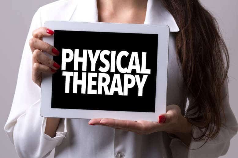 Women holding a sign saying Physical Therapy
